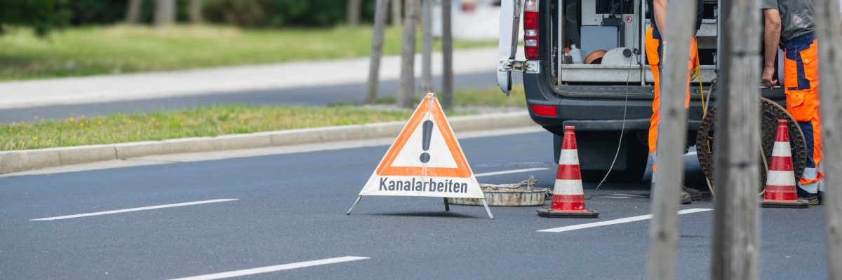 Kanalarbeiten Auf dem Foto erkennt man ein Fahrzeug sowie ein Warnschild mit dem Hinweis "Kanalarbeiten"